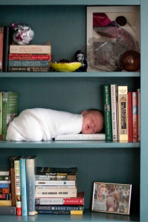 Baby asleep on bookshelf - Only a baby could be this cute