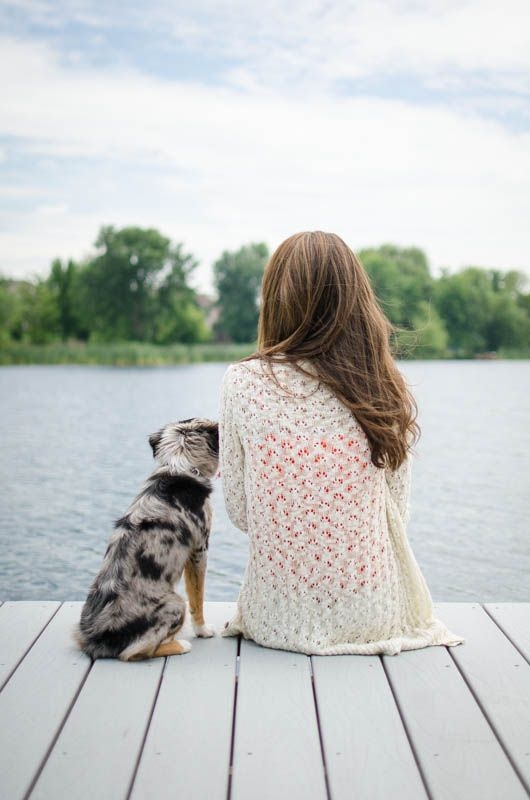 Austrailian Shepherd & girl sitting on the dock