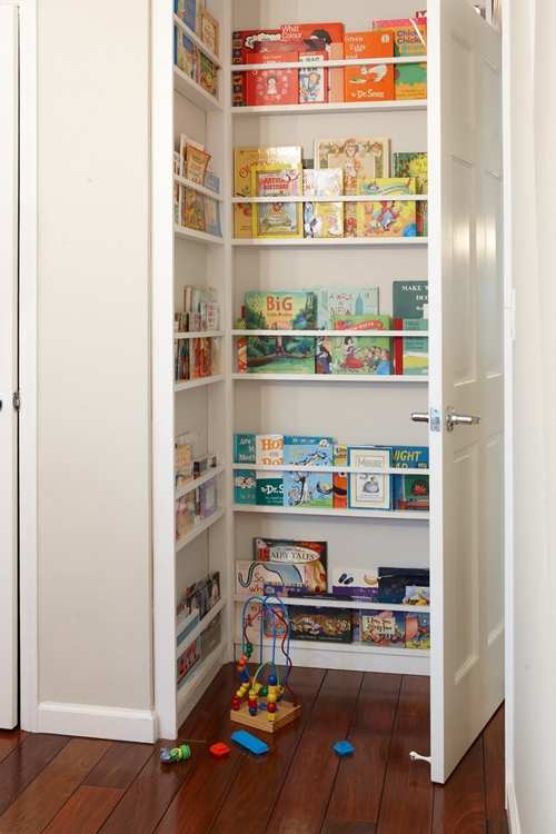 Corner bookshelf behind door