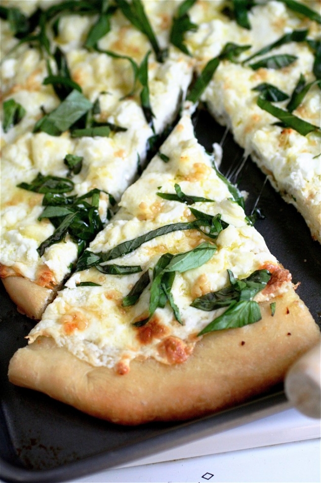 Four cheese white pizza with fresh basil, thyme & oregano