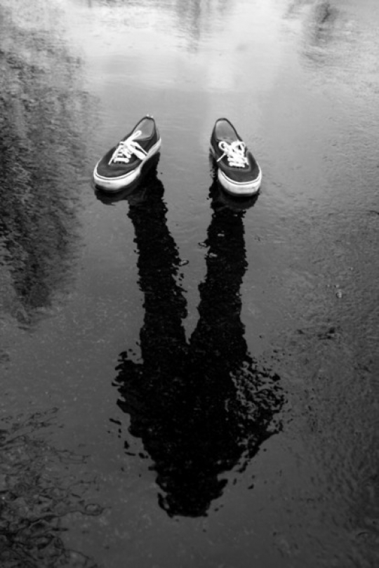 Cool photo of a person reflected on a wet surface