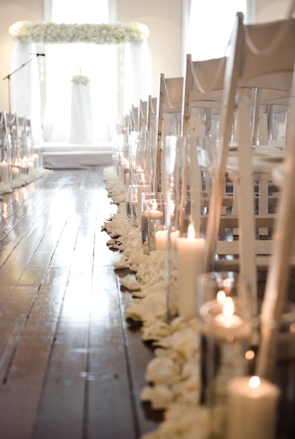 white flowers, and candles line the main isle