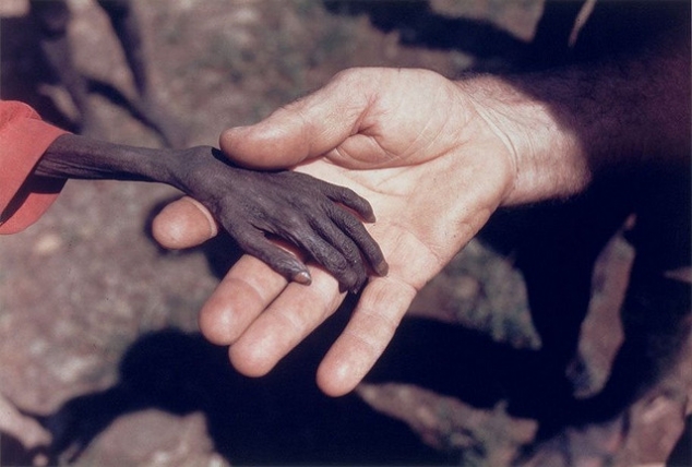 Starving boy and missionary by Mike Wells