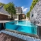 Visually stunning infinity edge pool with glass wall - Swimming Pools