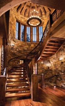 Massive wooden spiral staircase in large stone stairway - Dream house designs