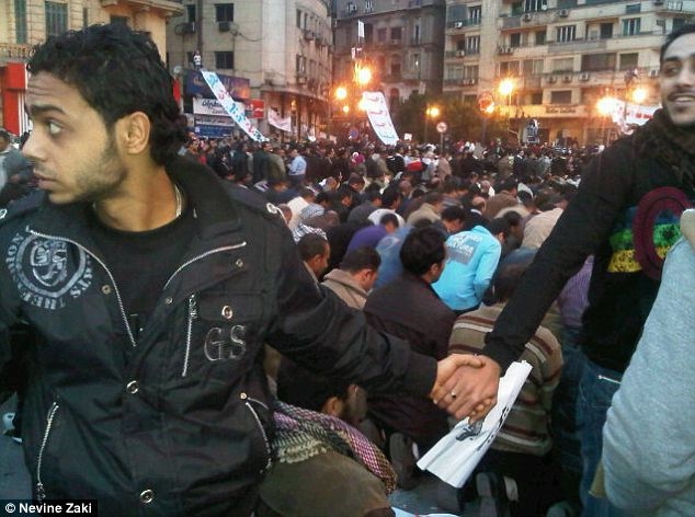 Christians protect Muslims during prayer in the midst of the 2011 uprisings in Cairo, Egypt