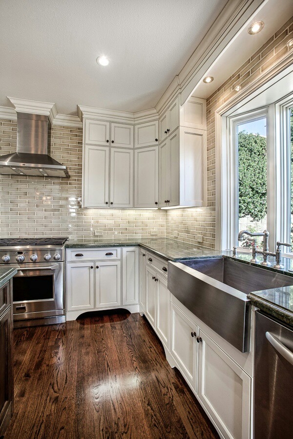 Kitchen with cream coloured subway tile walls