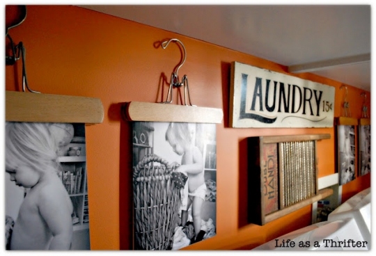 Decorating laundry room with photos hanging from hangers