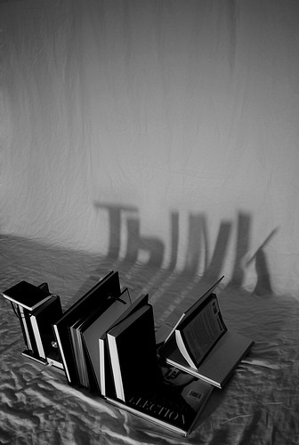 Books casting letters onto the wall