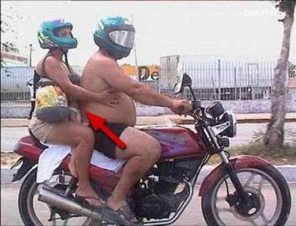 Parents sandwich child while riding motorbike