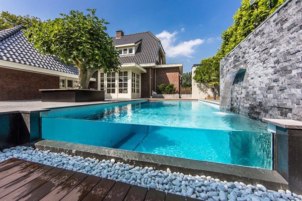 Visually stunning infinity edge pool with glass wall