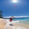 Kitesurfer skimming sandy beach [photo]