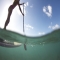 Stand Up Paddleboarding (SUP) in the clear waters of Hawaii